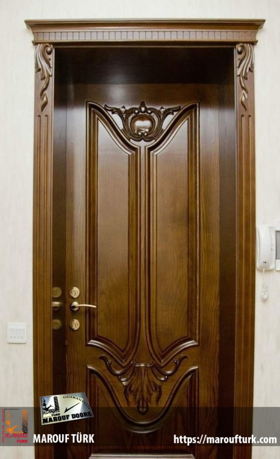 Classic dark wood-look entrance door with carved panels and decorative surround