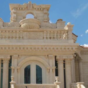 Classical decorative stone façade with columns, balustrades and an ornamental roofline
