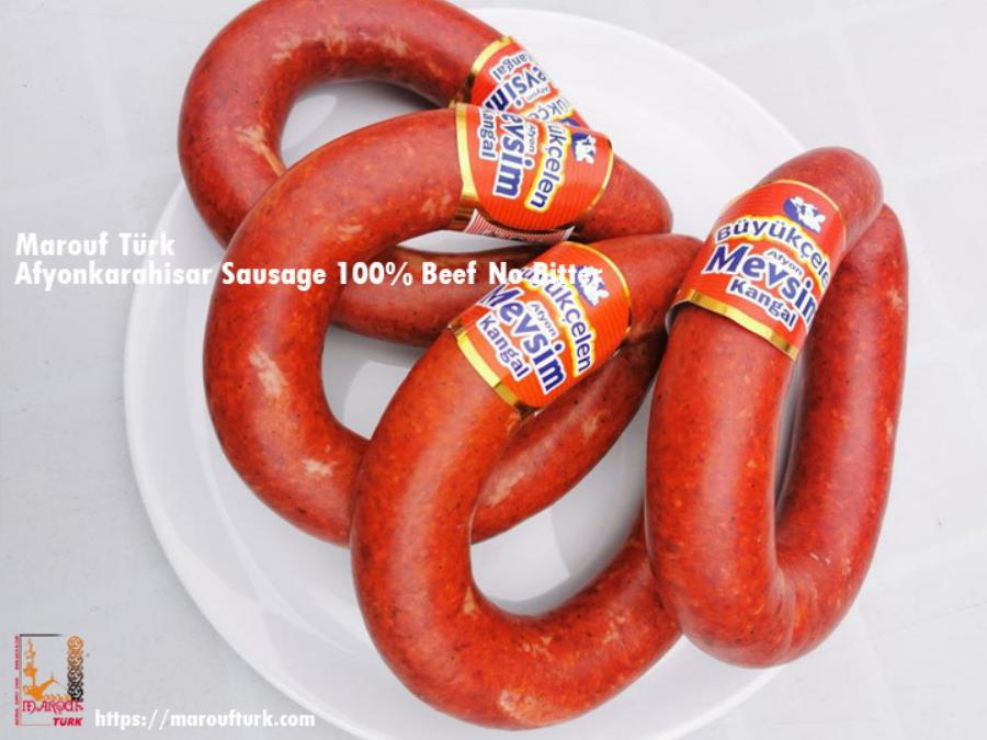 Turkish beef sausage rings on a white serving plate